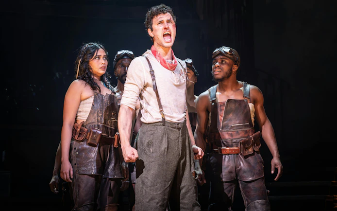 Performers on stage during Hadestown musical in West End.