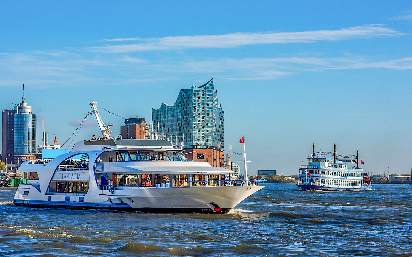 Harbor cruise boats near Elbphilharmonie in Hamburg.