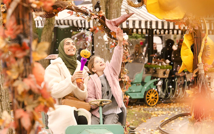 Guests enjoying a Halloween-themed ride at Tivoli Gardens, Copenhagen.