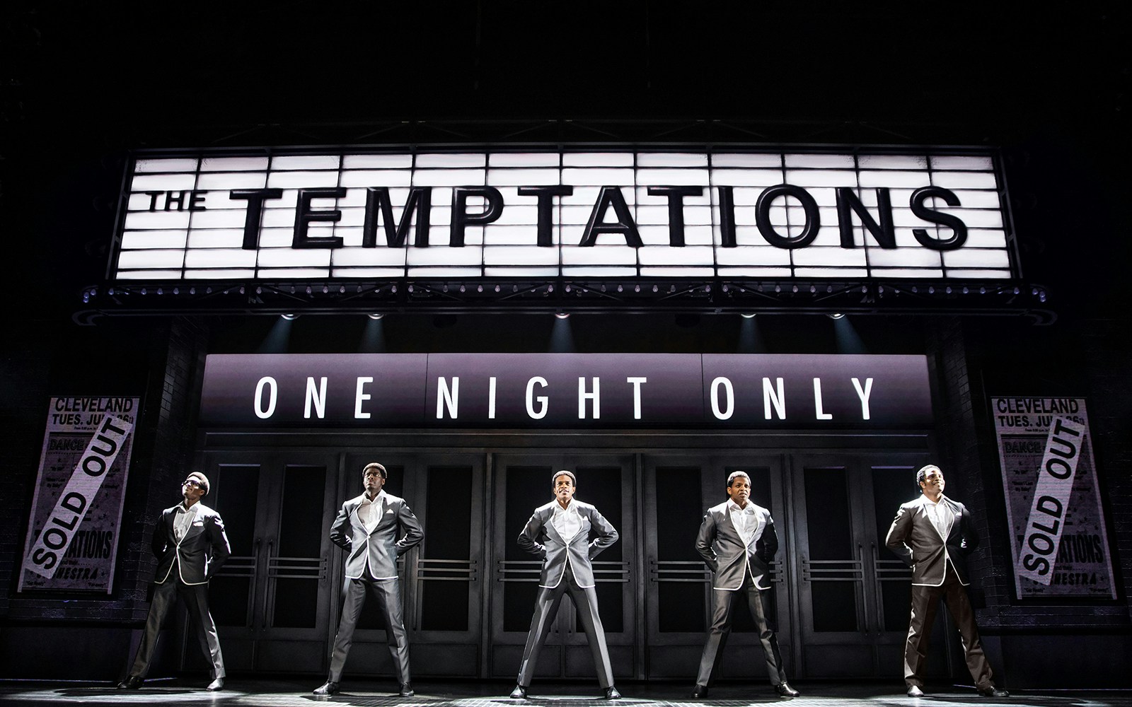 The Temptations musical performance, Ain't Too Proud, on stage with marquee sign.