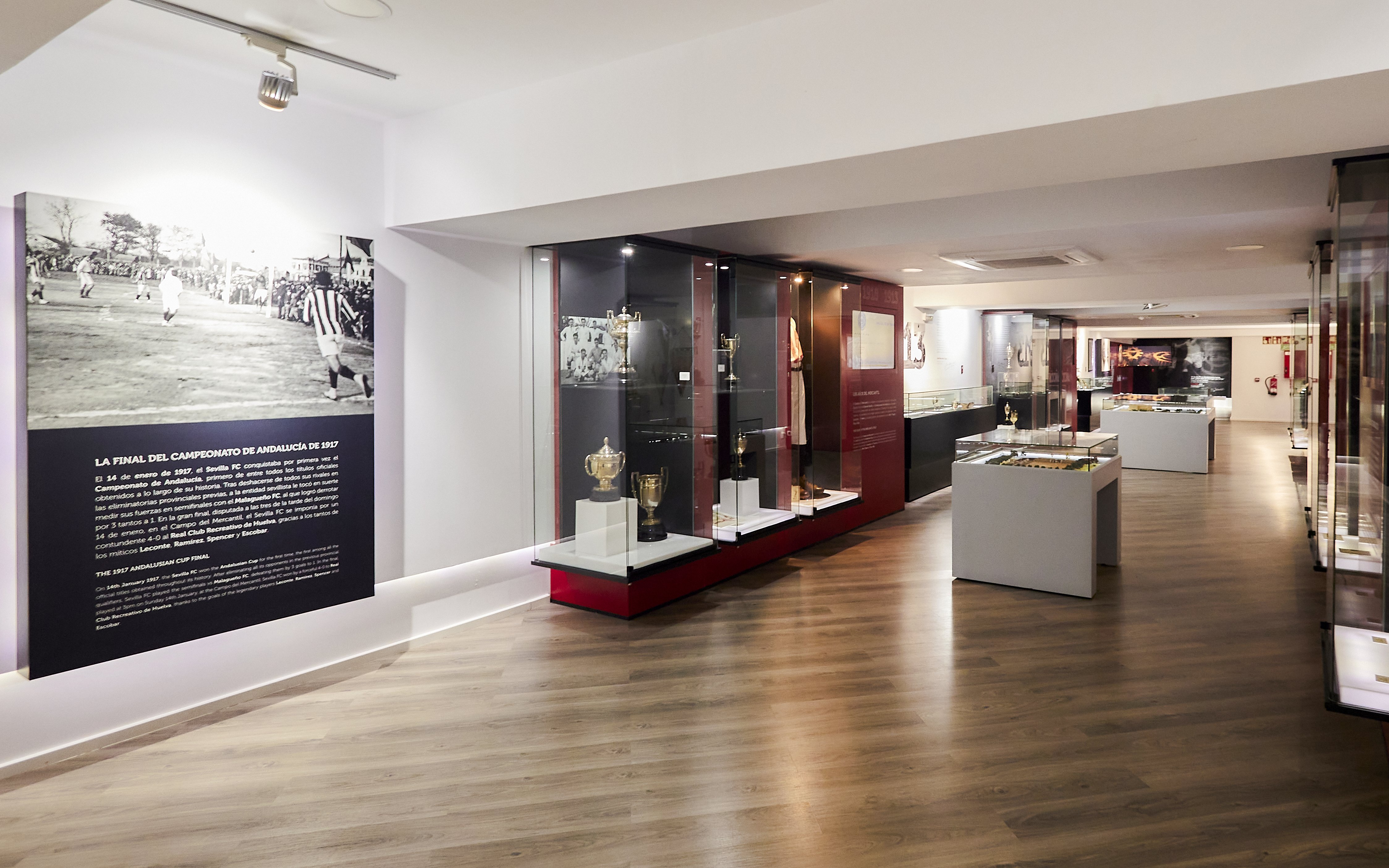 Sevilla FC History Experience museum interior with trophies and historical displays.