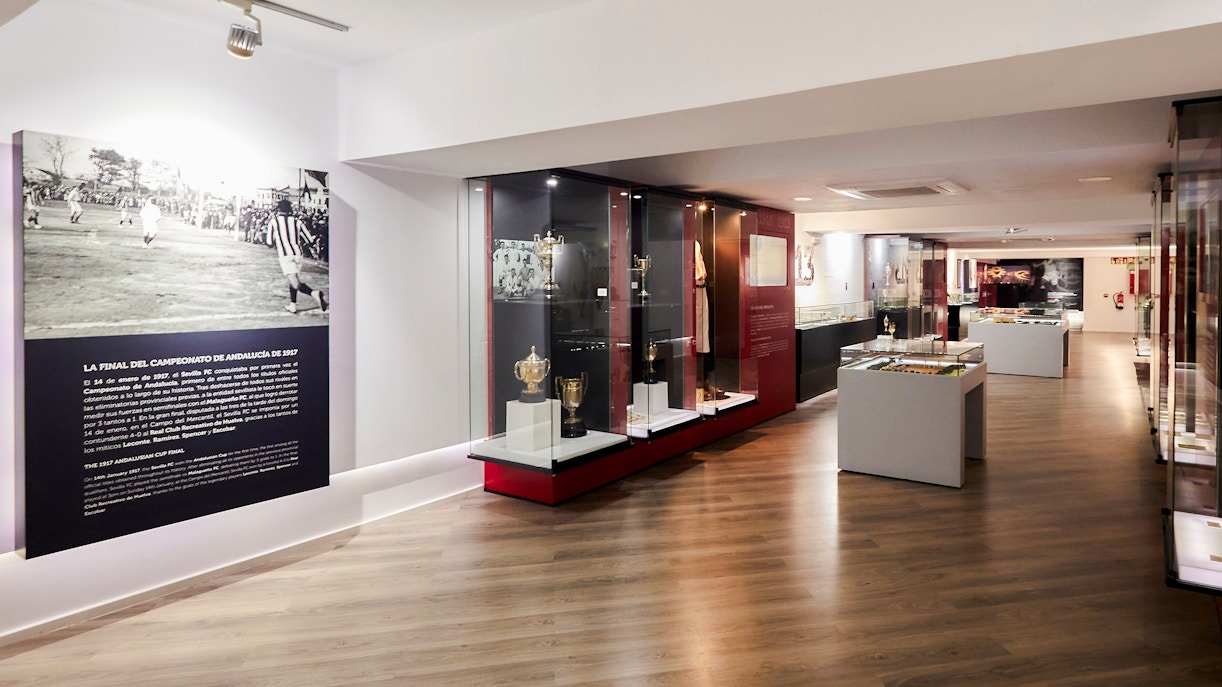 Sevilla FC History Experience museum interior with trophies and historical displays.