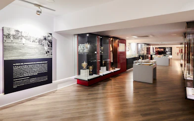 Sevilla FC History Experience museum interior with trophies and historical displays.