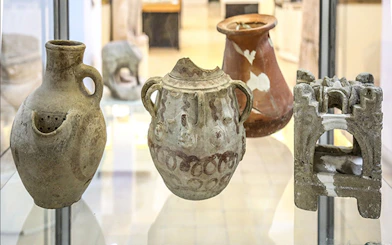 Ancient pottery artifacts displayed in a museum in Amman, Jordan.