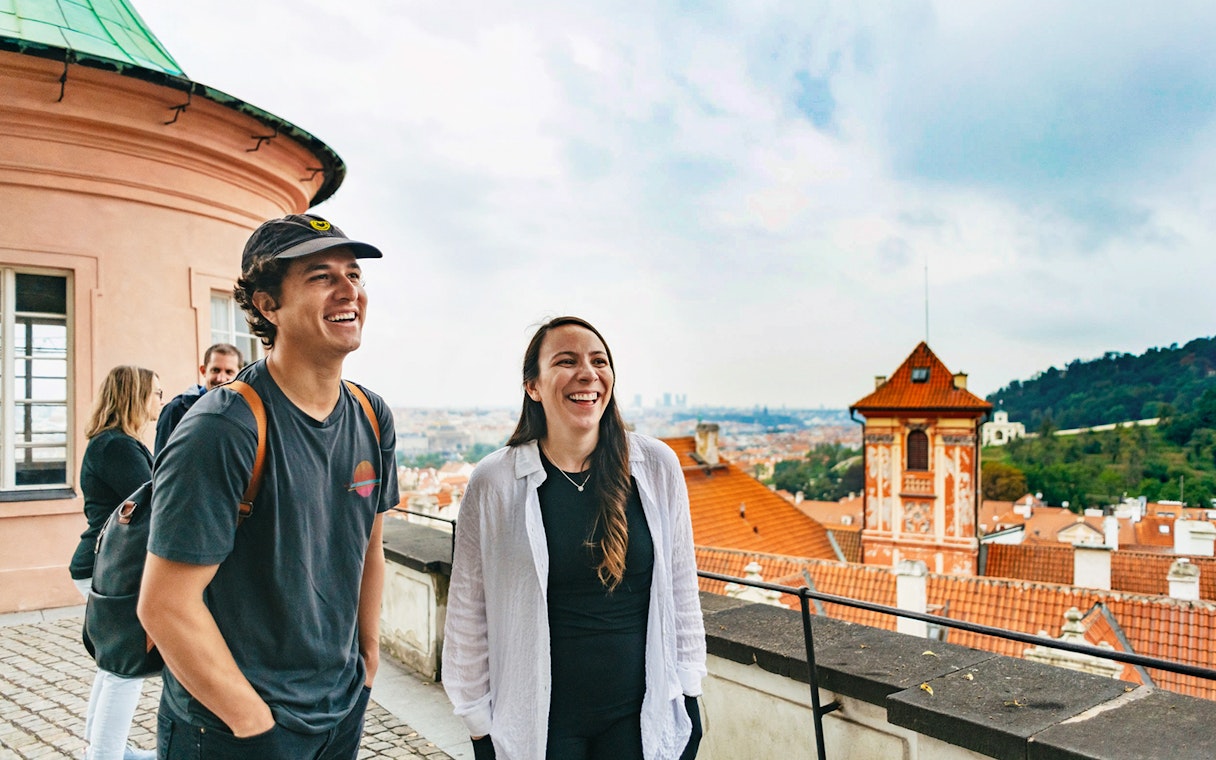 Tourists enjoying a view of Prague's historic architecture during a city tour.