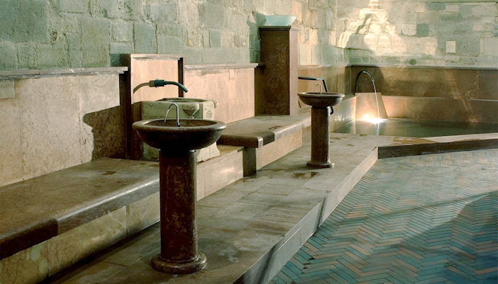 Rudas Thermal Spa interior with illuminated pools at night, Budapest, Hungary.