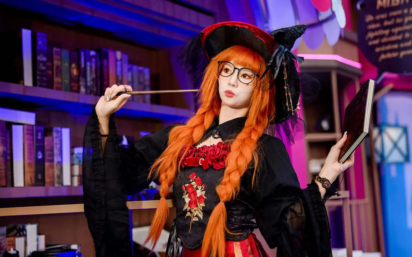Lady in costume holding a book and wand at Window of the World.