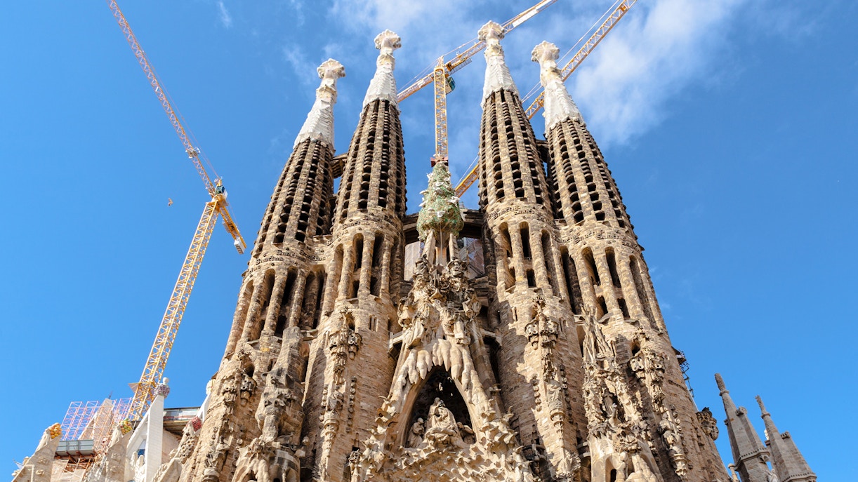 Sagrada Familia towers with cranes against blue sky, Barcelona.