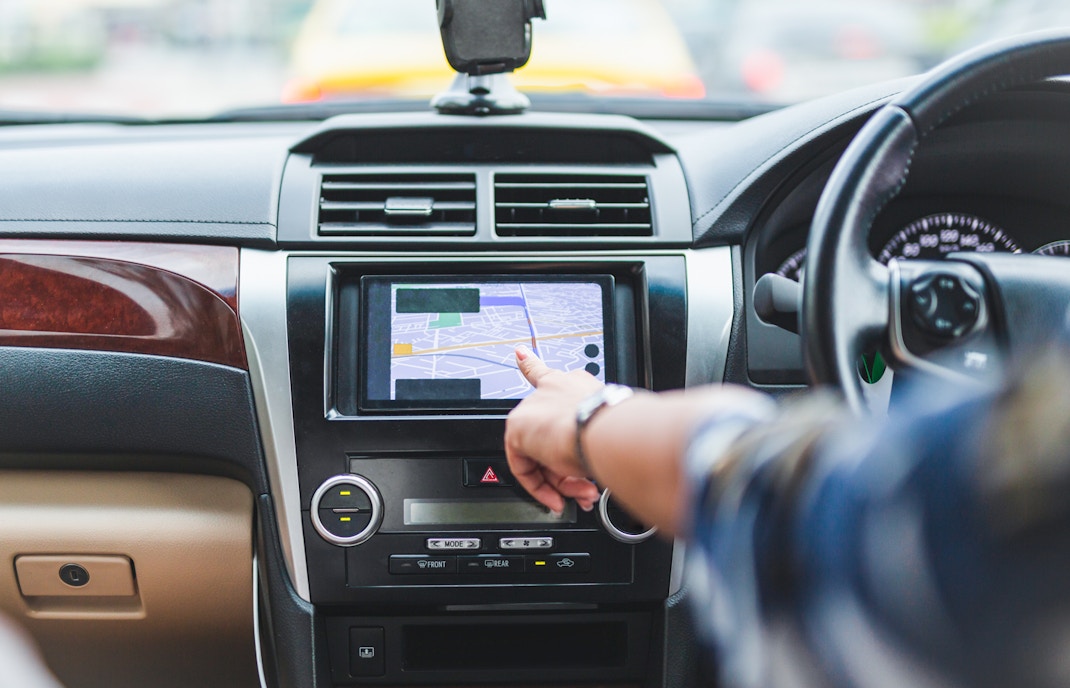 car with GPS navigation system in urban setting.