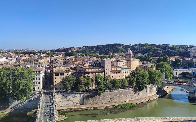View of Rome from Castel Sant'Angelo, featuring the Tiber River and historic buildings.