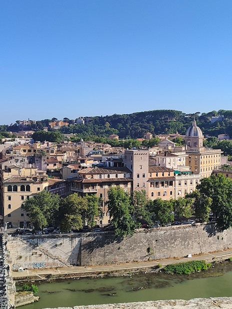 View of Rome from Castel Sant'Angelo, featuring the Tiber River and historic buildings.
