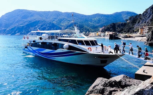 Tourists boarding a boat in La Spezia for a guided tour to Riomaggiore, Monterosso, and Vernazza.