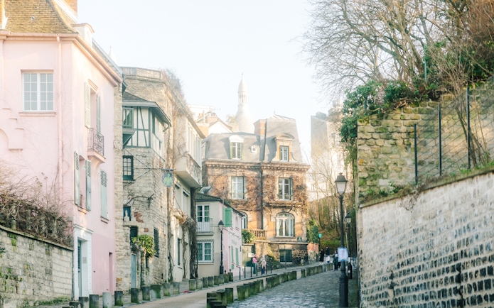 Montmartre street view with historic buildings on Emily in Paris walking tour.