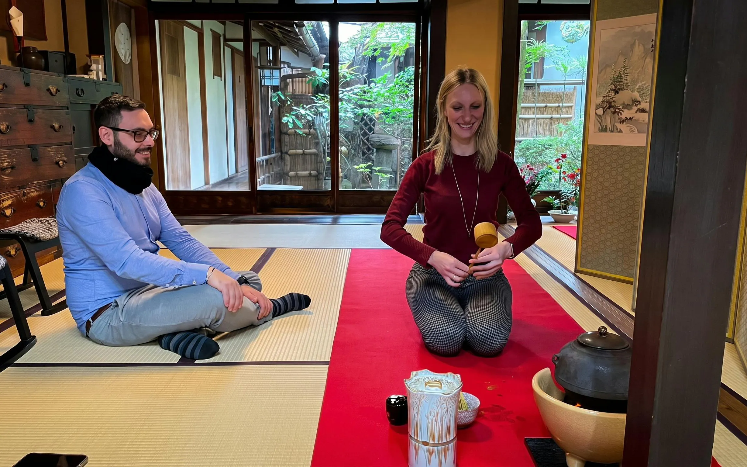 Couple participating in a tea ceremony in a traditional Kyoto tea room.
