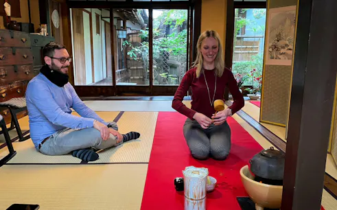 Couple participating in a tea ceremony in a traditional Kyoto tea room.