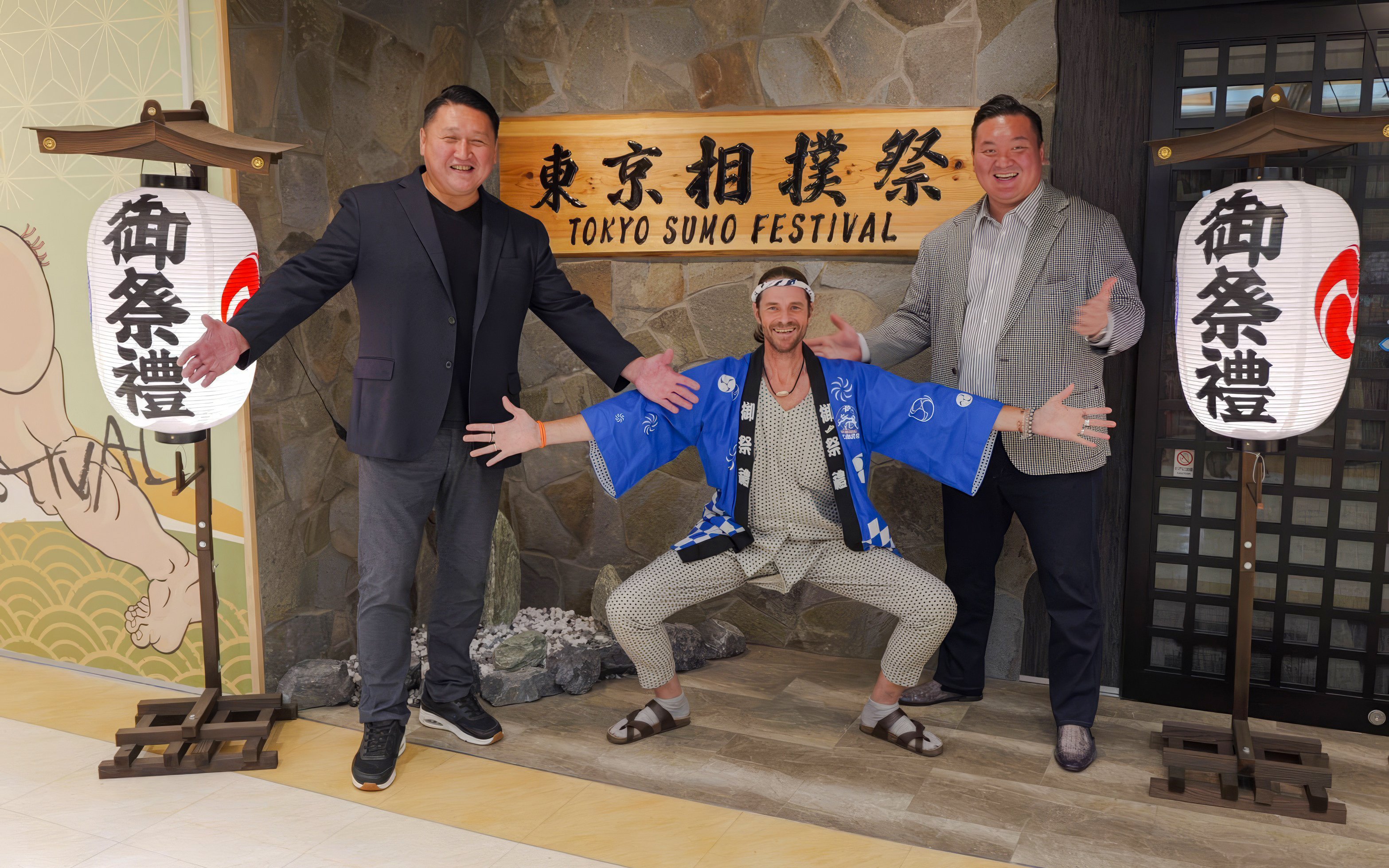 Ginza entrance with sumo show participants posing for souvenir photos.