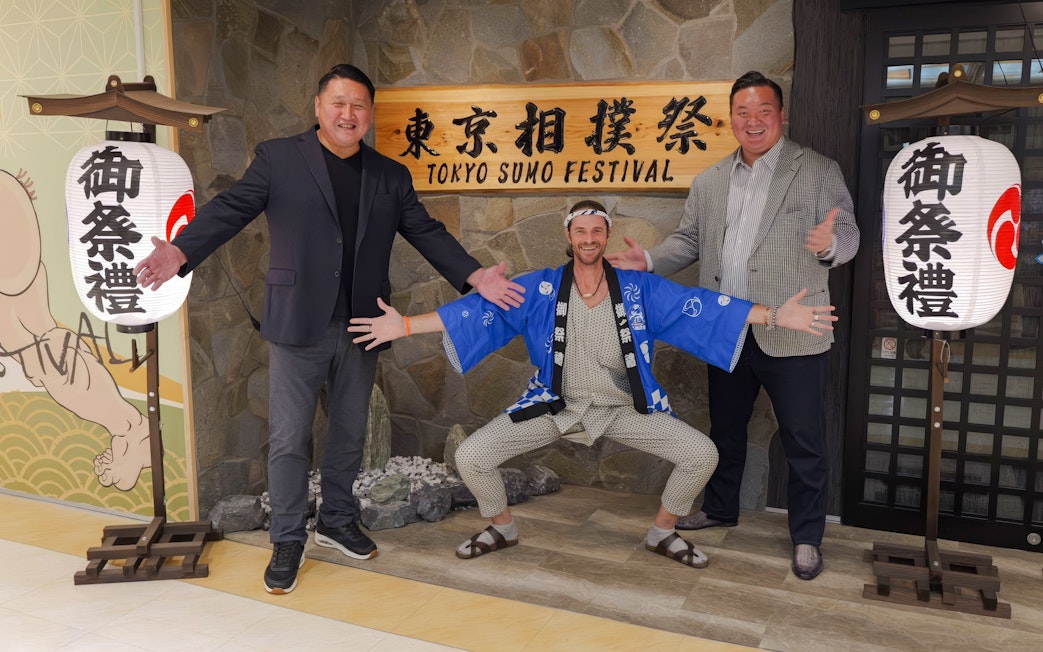 Ginza entrance with sumo show participants posing for souvenir photos.