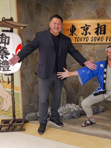 Ginza entrance with sumo show participants posing for souvenir photos.