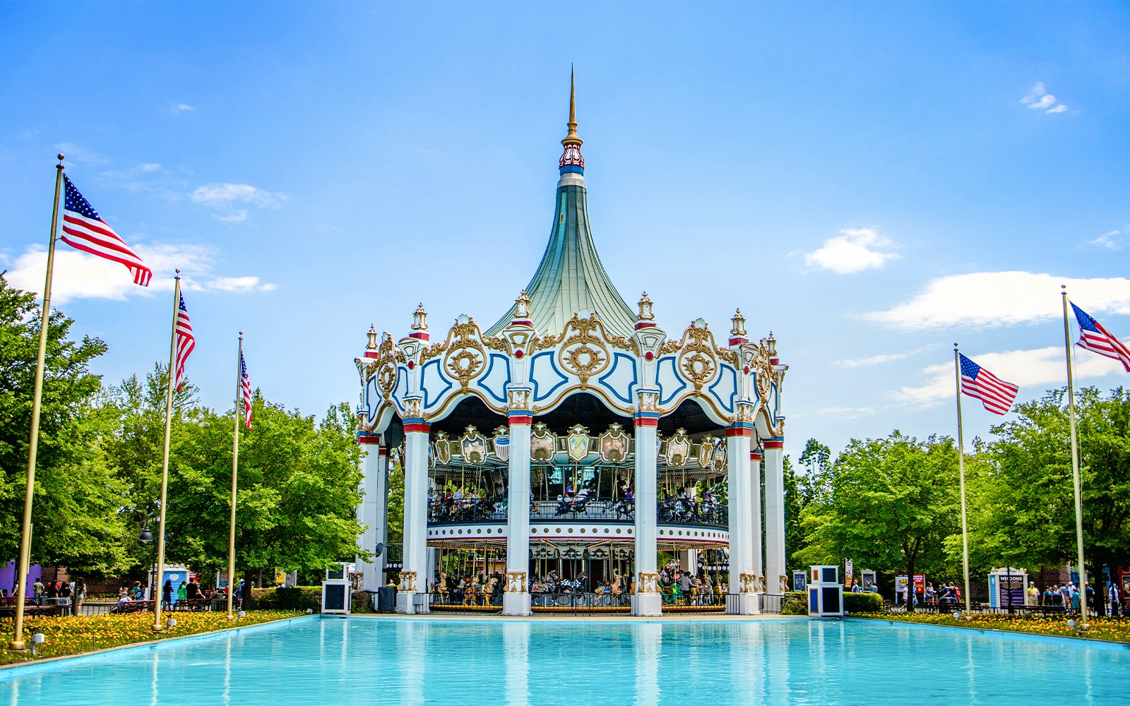Columbia Carousel at Six Flags Great America with surrounding flags and water.
