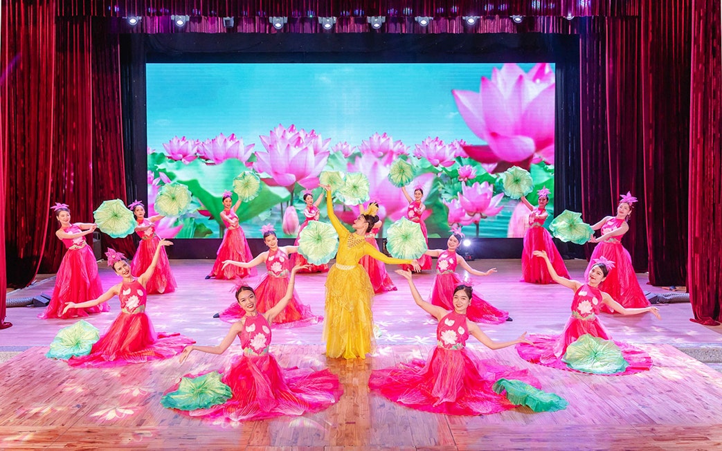 Performers in traditional Ao Dai costumes during a cultural show in Da Nang.