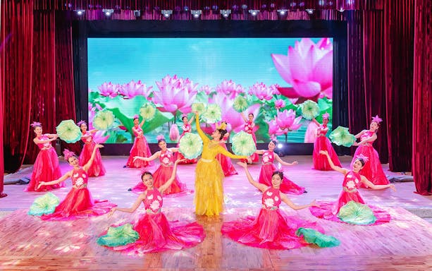Performers in traditional Ao Dai costumes during a cultural show in Da Nang.