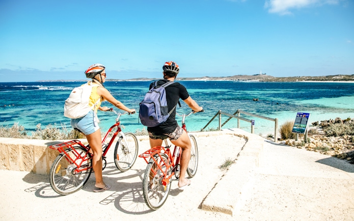 Cyclists overlooking ocean view on Rottnest Island, part of Perth snorkel tour.
