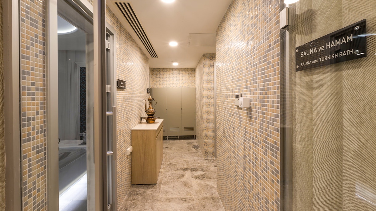 Turkish bath interior with marble basins and towels in Taksim, Istanbul.