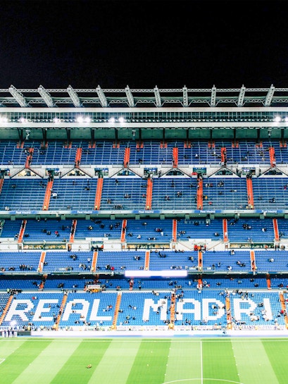 Bernabeu Stadium seating area in Madrid, showcasing "Real Madrid" signage.