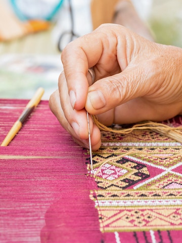 Hand weaving intricate silk pattern at Valencia Silk Museum.