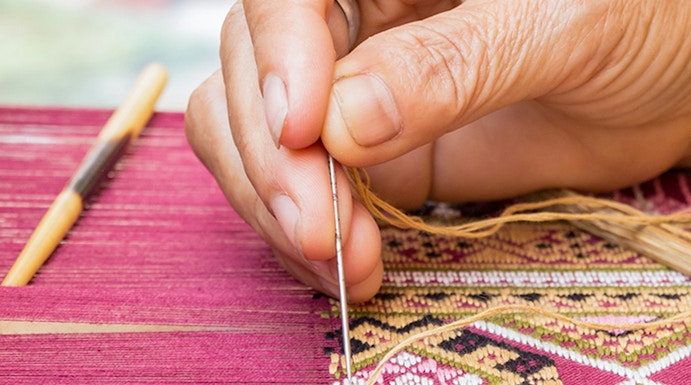 Hand weaving intricate silk pattern at Valencia Silk Museum.