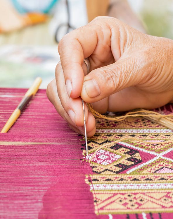 Hand weaving intricate silk pattern at Valencia Silk Museum.