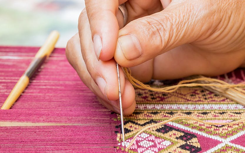 Hand weaving intricate silk pattern at Valencia Silk Museum.