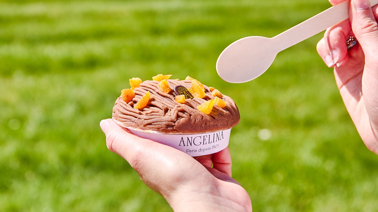Person holding Mont Blanc dessert from Angelina Rivoli, Paris, with a spoon.