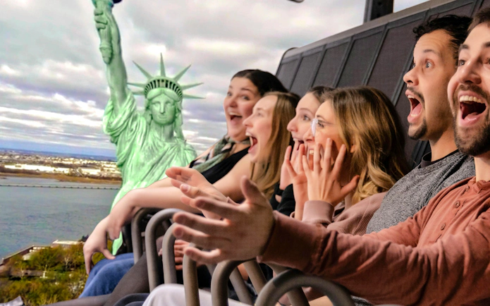 Guests enjoying a simulated ride at RiseNY with a view of the Statue of Liberty.