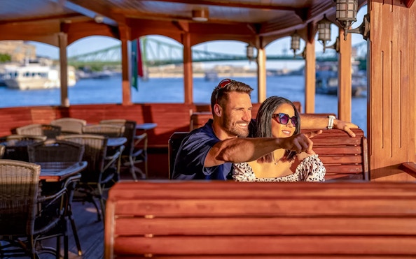 Guests enjoying a scenic view on a historic cruise in Budapest.