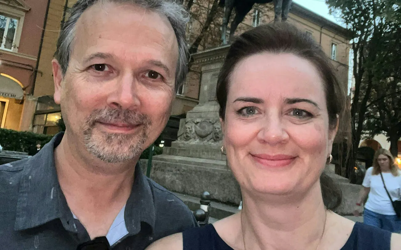 Couple enjoying Bologna's historic center during a self-guided murder mystery game.
