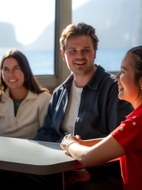 Milford Sound cruise passengers enjoying scenic views from the boat.