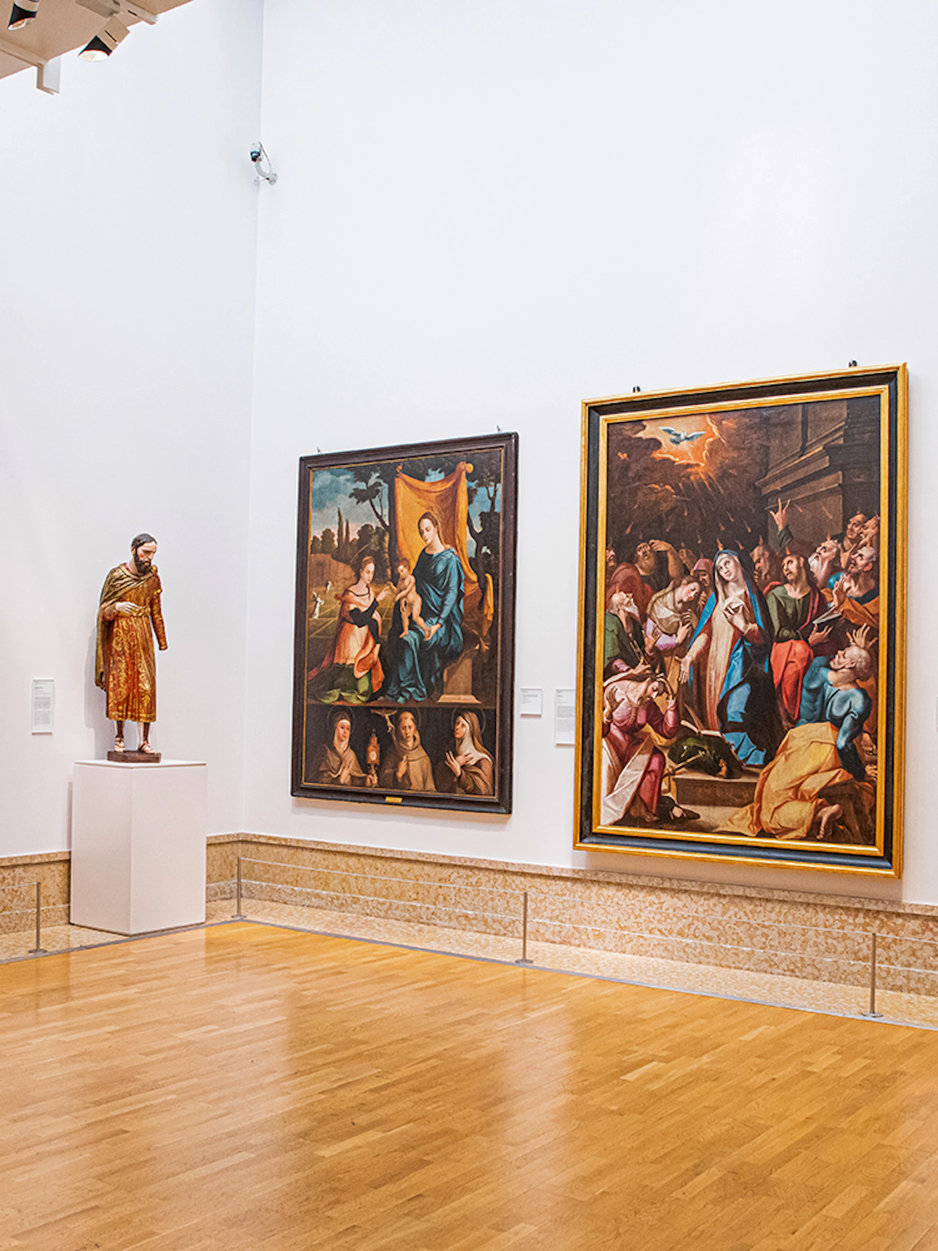 National Museum of Ancient Art gallery with religious paintings and a sculpture.