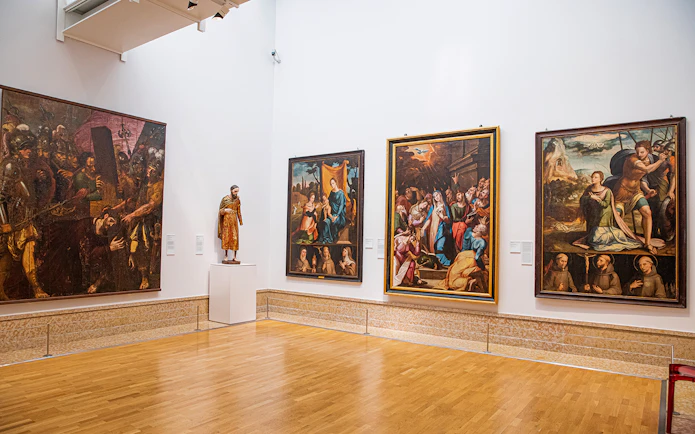 National Museum of Ancient Art gallery with religious paintings and a sculpture.