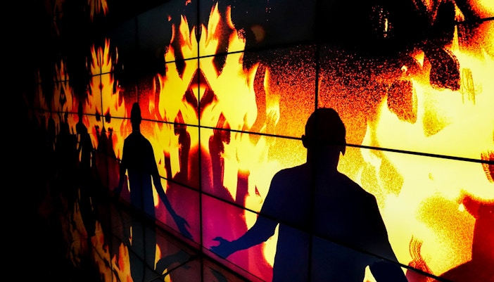 Silhouettes against flames at the firefighter exhibition in New Mill Water Tower, Prague.