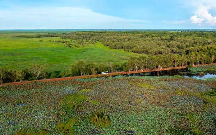 Bus traveling through lush landscape in Litchfield National Park, near Darwin.