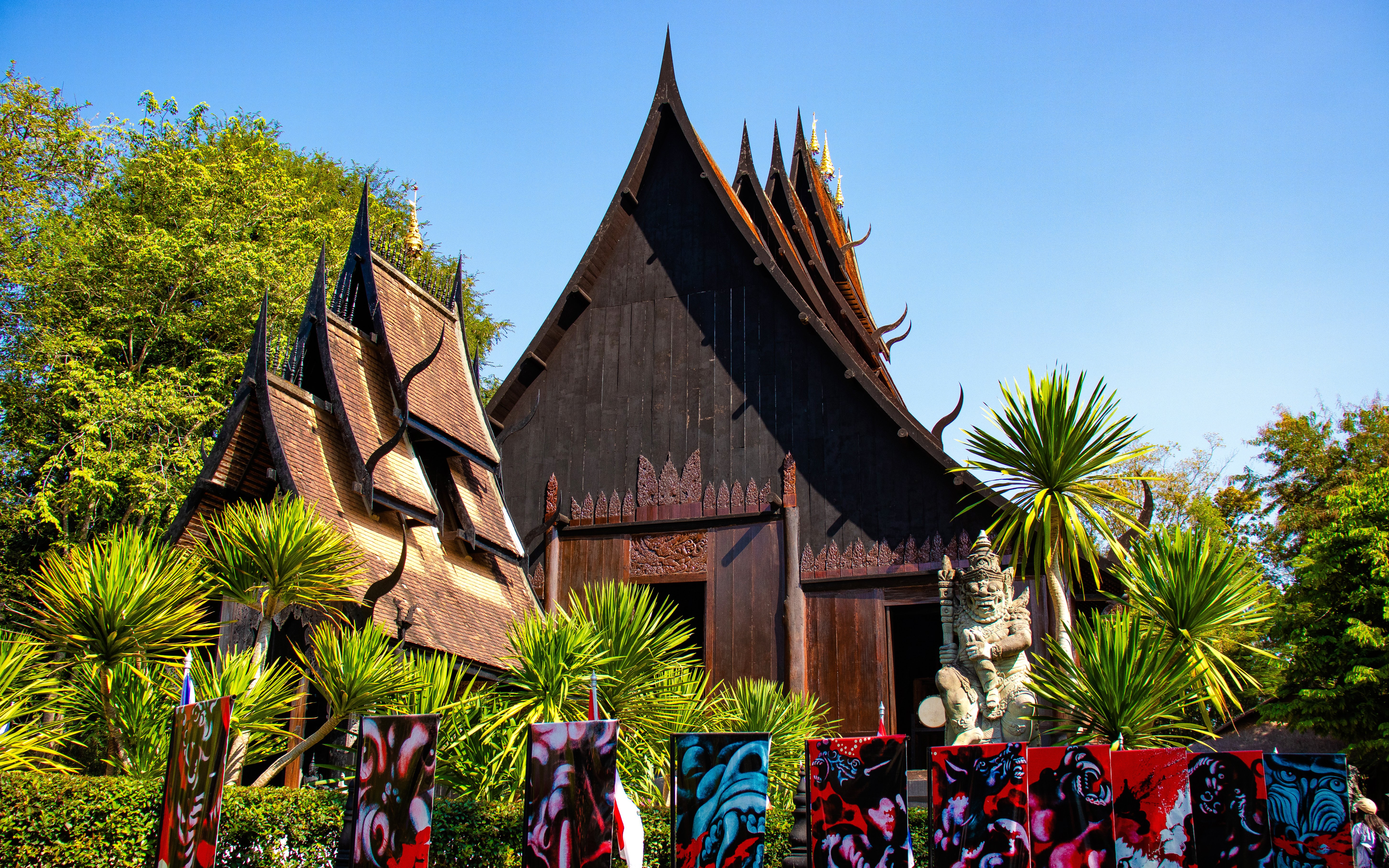 Baan Dam Museum's black temple with intricate roof design in Chiang Rai, Thailand.