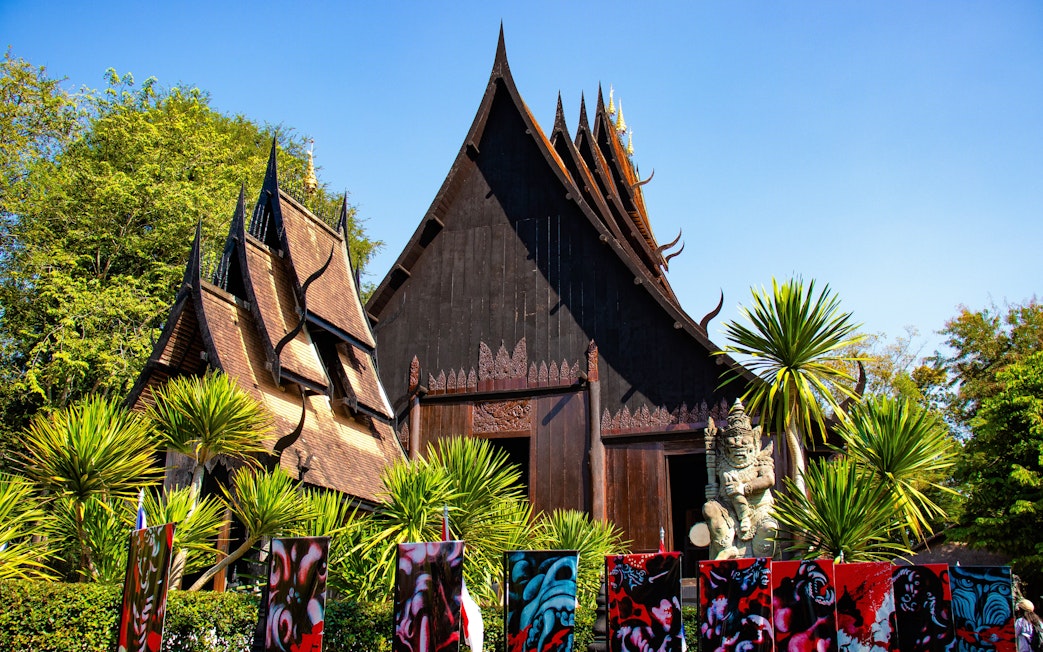 Baan Dam Museum's black temple with intricate roof design in Chiang Rai, Thailand.