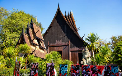 Baan Dam Museum's black temple with intricate roof design in Chiang Rai, Thailand.