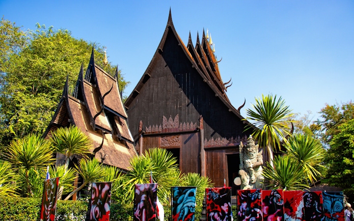 Baan Dam Museum's black temple with intricate roof design in Chiang Rai, Thailand.