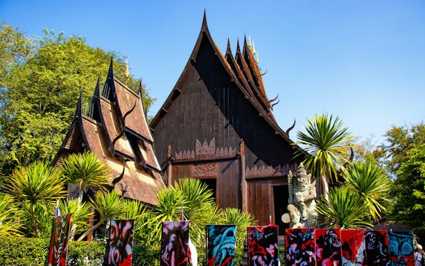 Baan Dam Museum's black temple with intricate roof design in Chiang Rai, Thailand.