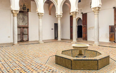 Tangier's Kasbah courtyard with mosaic tiles and central fountain.