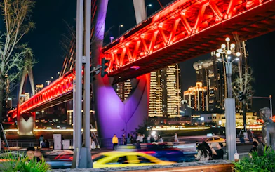 Chongqing night view with illuminated bridge and city skyline.