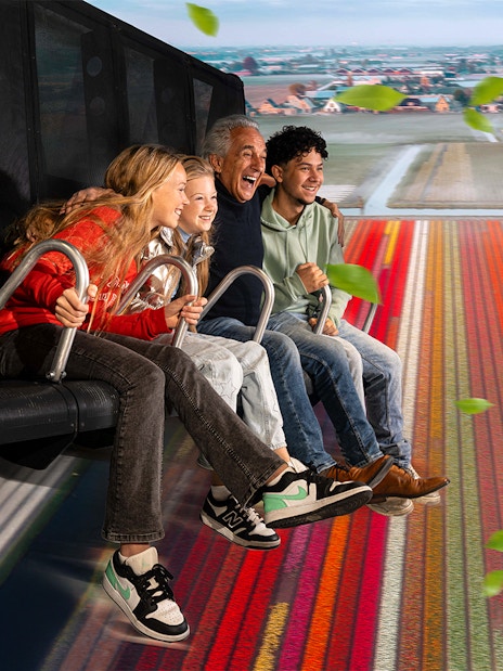 Tourists experiencing 5D ride at This Is Holland, flying over Dutch tulip fields.