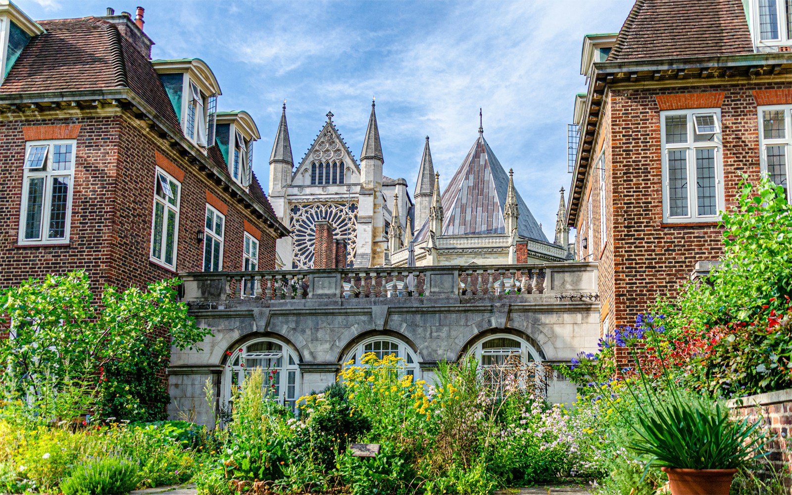 Gothic architecture of Westminster Abbey viewed from a garden in London.